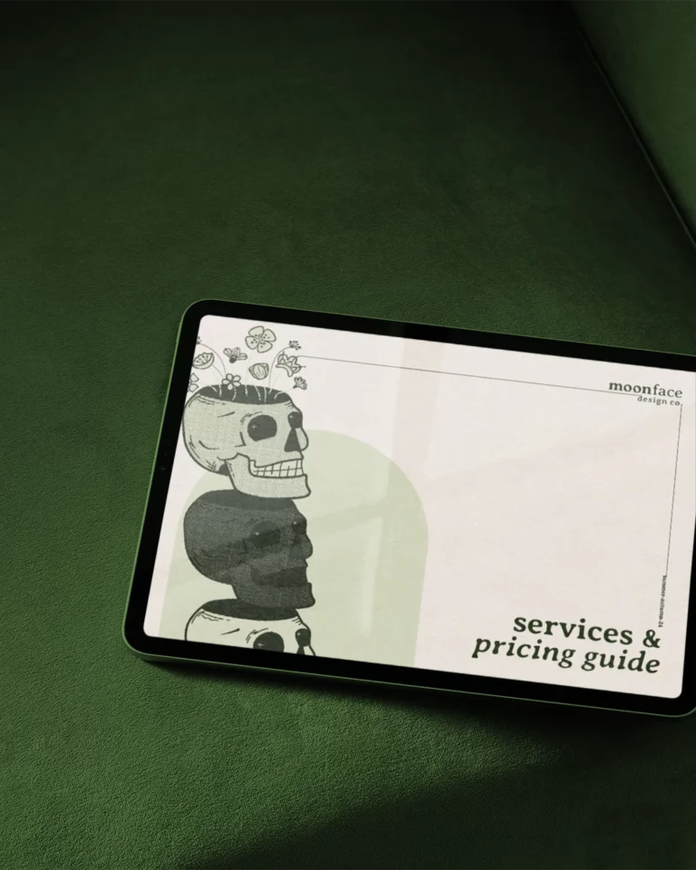 tablet sitting on dark green velvet couch showing the cover of the moonface design co. services and pricing guide. the cover is off white with a light green arch in the bottom left corner, framing three hand-illustrated skulls stacked on top of each pther with different halftone effects all in a monochromatic, vintage-inspired colour scheme.